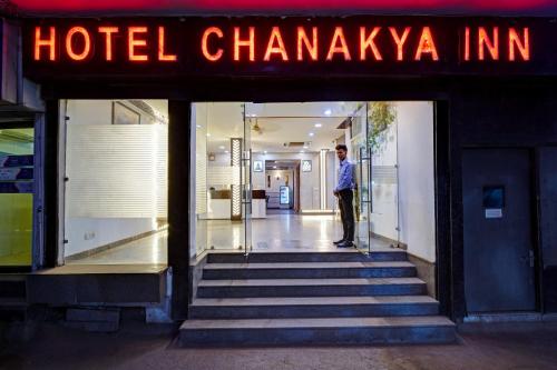 a man standing in the doorway of a hotel pharmacy at Hotel Chanakya Inn in New Delhi