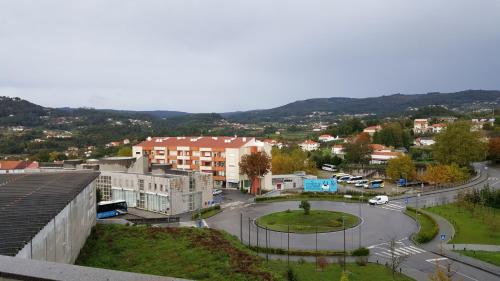 a view of a city with a street and buildings at Residencial Albergaria in Paredes de Coura