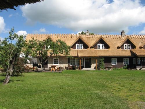 a large house with a green yard in front of it at Jurna Recreation Farm in Upa