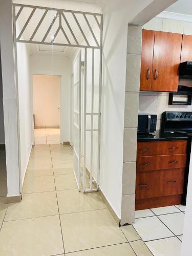 a kitchen with a door leading into a hallway at Violet in Ermelo