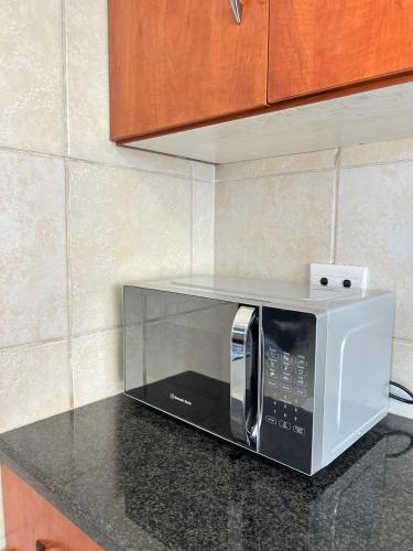 a microwave sitting on a counter in a kitchen at Violet in Ermelo