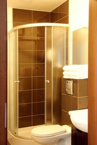 a bathroom with a shower with a toilet and a sink at Rest- Pokoje z Łazienkami in Gdynia