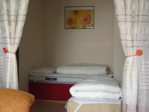a room with two beds and a picture on the wall at Apartment Natik in Ax-les-Thermes