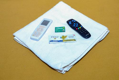 a remote control and other items on a napkin at Maharashtra Guest House in Kalyan