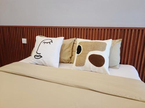 a bed with pillows with a picture of a man at Imperio Melaka Standard Suites by Jeffery Lam Home Management in Melaka