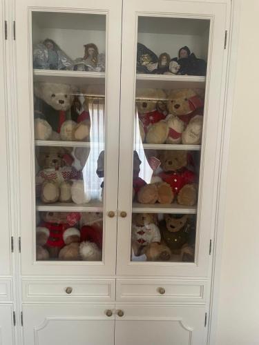 a white cabinet filled with lots of teddy bears at Suite Romantic vista Lago in Stresa
