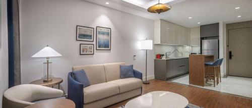 a living room with a couch and a kitchen at Hilton Mall Of Istanbul in Istanbul