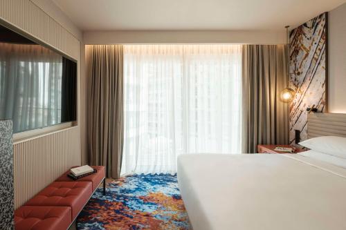 a hotel room with a large bed and a window at Hyatt Centric Malta in St. Julianʼs