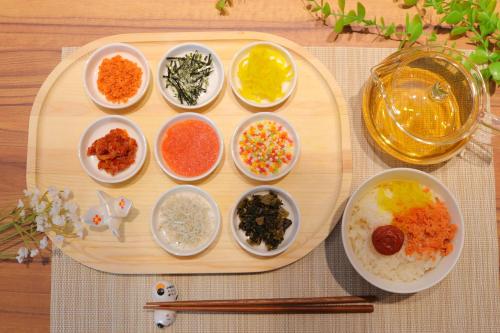 a wooden tray with bowls of different types of food at Hiyori Hotel Osaka Namba Station in Osaka