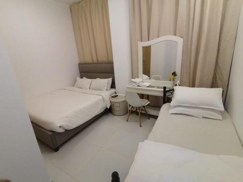 a small room with two beds and a mirror at International City CBD 2 in Dubai