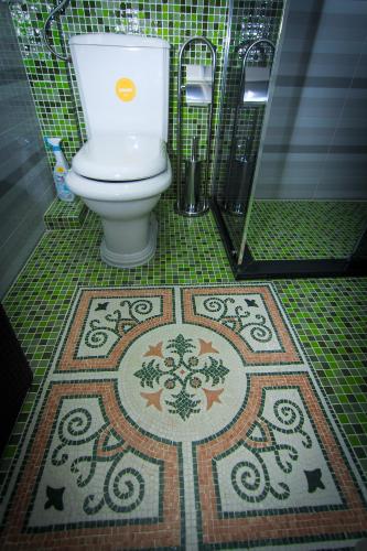 a bathroom with a toilet with a tile floor at Apartment Red House in Visoko