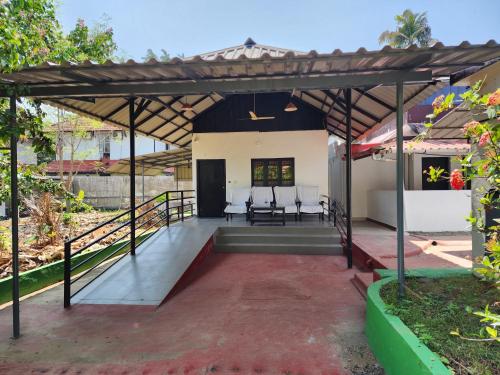 a view of the front porch of a house at ILLIKKALAM Lakeside Cottages Kumarakom Kerala in Kumarakom