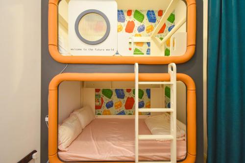 an orange bunk bed in a small room at D'Pristine Theme Suite by Nest Home at LEGOLAND in Nusajaya