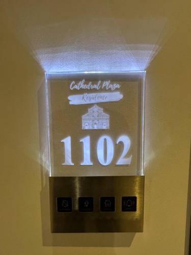 a clock on a wall with the number at Hotel Boutique Cathedral Plaza Residences room for rent downtown in Bucharest