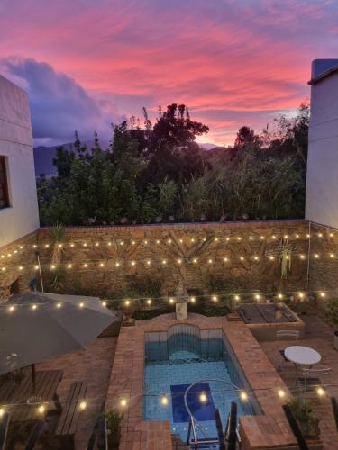 a view of a swimming pool with a sunset at Barrydale Karoo - BOUTIQUE HOTEL in Barrydale