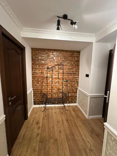 a room with a brick wall and a chair at Hotel Boutique Cathedral Plaza Residences room for rent downtown in Bucharest