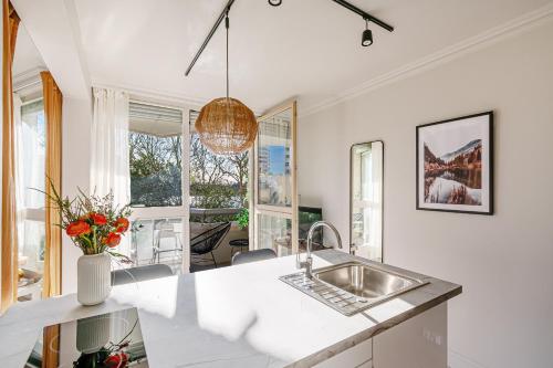 a kitchen with a sink and a table at The Lake Aurora Suite - Duke Housing in Créteil
