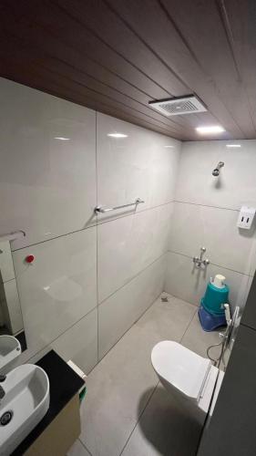 a bathroom with a toilet and a sink at Fortune Retreats in Ooty