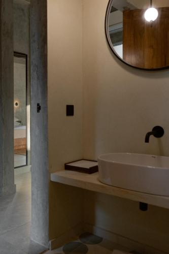 a bathroom with a sink and a mirror on the wall at Maro Garden in Ahangama