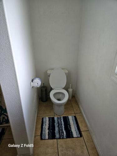 a small bathroom with a toilet in a corner at Yonegan Maui Getaways - Haiku in Haiku