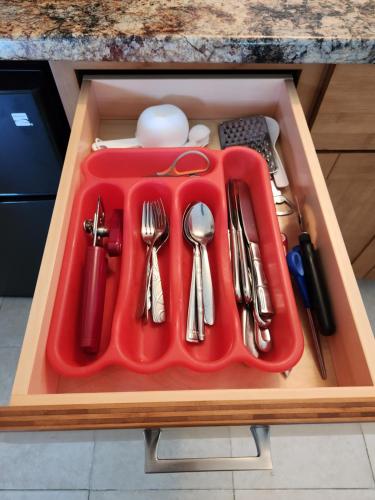 a red tray with utensils in a drawer at Yonegan Maui Getaways - Haiku in Haiku