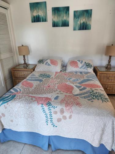 a bed with a comforter and pillows on it at Yonegan Maui Getaways - Haiku in Haiku