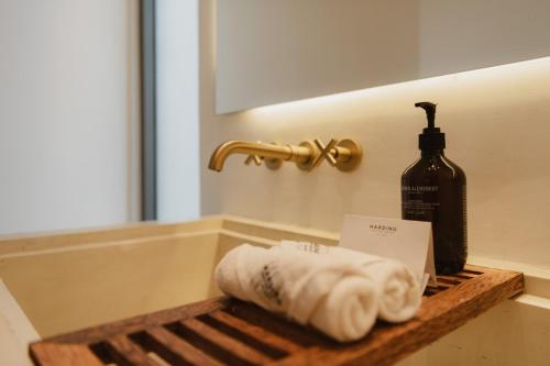 a stack of towels on a shelf in a bathroom at Harding Boutique Hotel in Ahangama