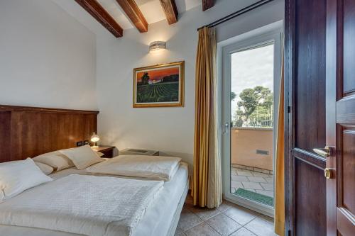 a bedroom with a bed and a sliding glass door at Villa Marittima in Izola