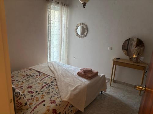 a bedroom with a bed and a mirror and a table at rosi rhodos in Rhodes Town