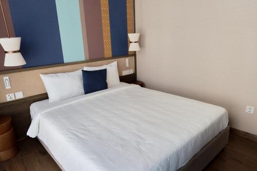 The Apec Mandala Ocean View Mui Ne - Condotelにあるベッド
