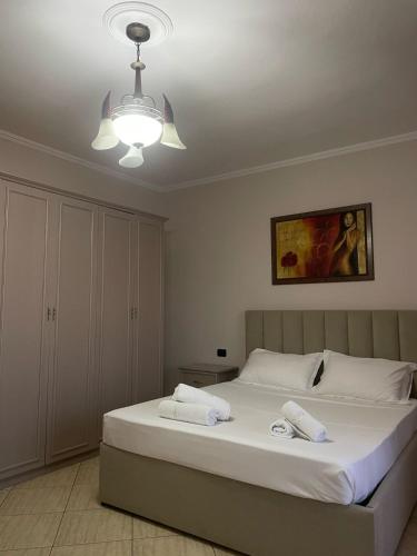 a bedroom with a bed with two towels on it at Hotel Kloest in Durrës