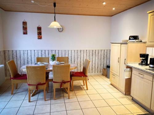 a dining room with a table and chairs in a kitchen at Ferienwohnung Jaeschke_ 25669 in Weener