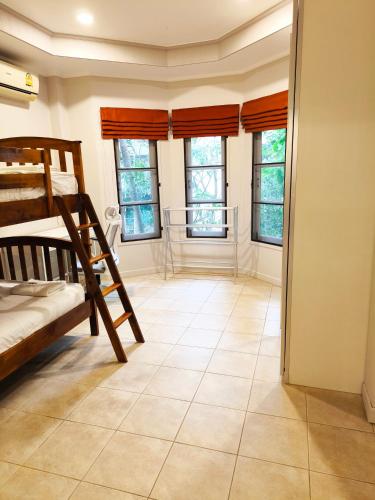 a bedroom with bunk beds and a tiled floor at Samui Green Life in Bophut 