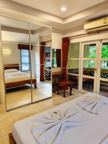 a bedroom with a bed and a mirror at Samui Green Life in Bophut 