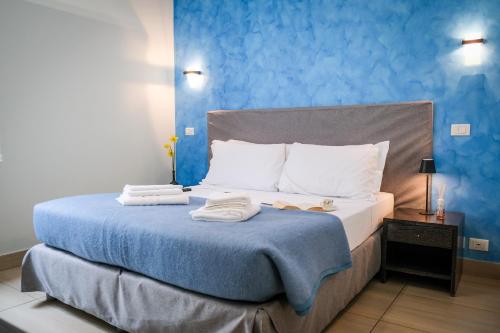 a bedroom with a bed with towels on it at Mocenigo Vatican Suites in Rome