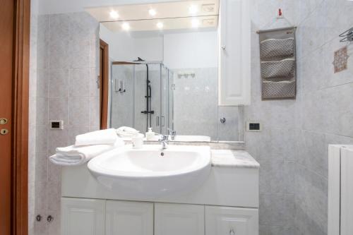 a white bathroom with a sink and a shower at Orio Stay&Fly in Orio al Serio