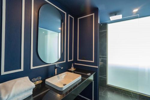 a bathroom with a sink and a mirror at Krabi Tipa Resort in Ao Nang Beach