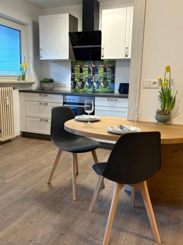 a kitchen with a wooden table and two chairs at Alm Studio 22 - Thymian - Ferienwohnung in Fischen in Fischen