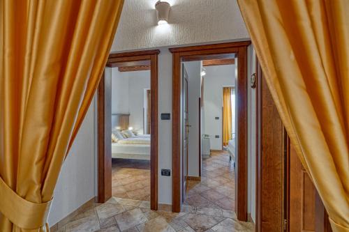 a room with yellow curtains and a bedroom with a bed at Villa Marittima in Izola