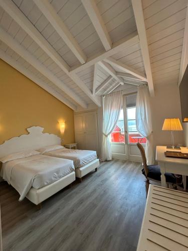 Postel nebo postele na pokoji v ubytování Hotel Cannero