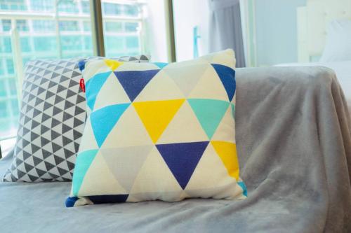 a colorful pillow sitting on top of a couch at -Garden View- Mount Austin Aeon IKEA 10 mins - A13A in Johor Bahru