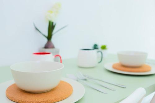 a table with two cups and plates on it at -Garden View- Mount Austin Aeon IKEA 10 mins - A13A in Johor Bahru