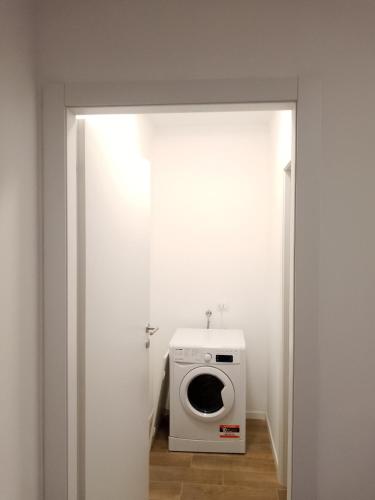 a bathroom with a washing machine in a room at Ripamonti Vill Olimpico LeCase&Vacanze Ambrosiane in Milan