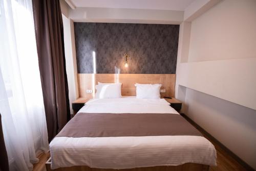 a bedroom with a large bed in a room at Astana Palace in Gori