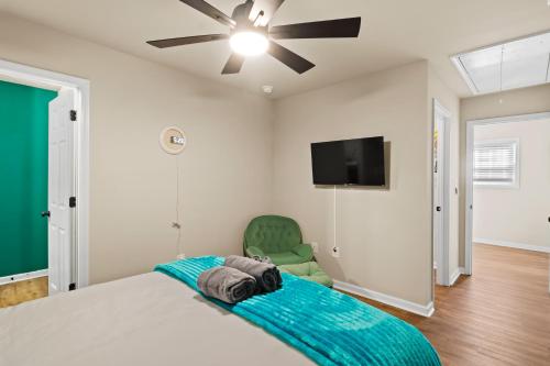 a bedroom with a bed and a flat screen tv at Cozy & Spacious 2 King Beds Near UGA & Downtown in Athens