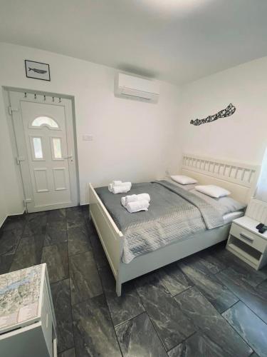 a bedroom with a bed with two towels on it at Garda Apartman in Balatonfenyves