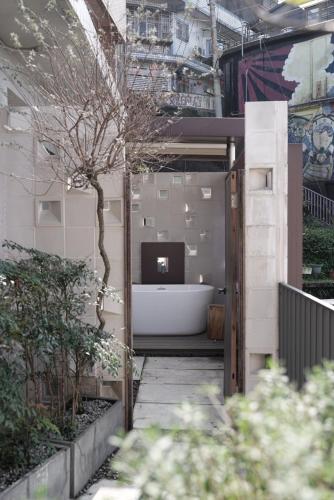 a bathroom with a bath tub and a television in a building at Jiufen 35 in Jiufen