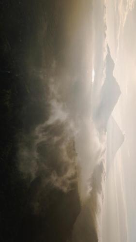a cloudy sky with the sun in the sky at The Kayuan in Kintamani
