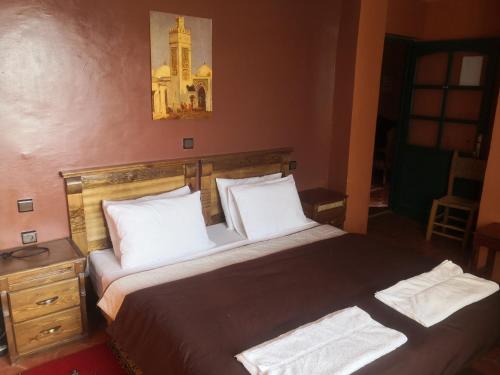 a bedroom with a bed with two white pillows at Auberge Kasbah Amoun in Taliouine