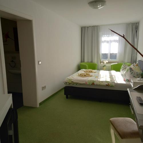 a bedroom with a bed with a green carpet at Dampfschiffhotel in Stadt Wehlen